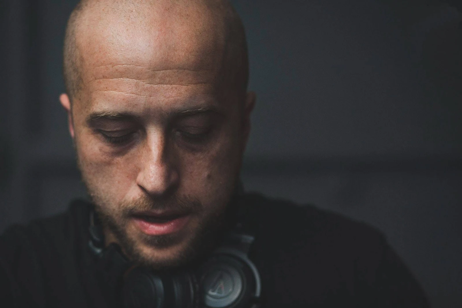 A.Paul wearing headphones in a close portrait