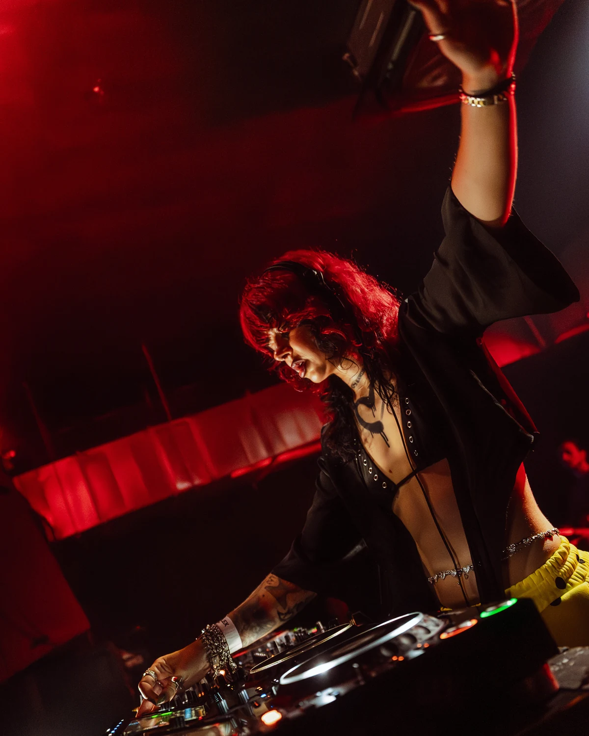 Anastasiya Ty performing under red stage light